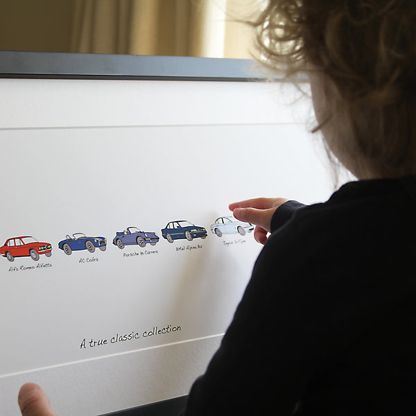 Car gift for dad. Pointing at artwork. Artwork includes persons car history. Maserati. Range Rover sport. Porsche Boxster S. Porsche panamera s. Jaguar s-type. pointing at an audi r8. Your life in cars framed artwork. child pointing at car artwork. Framed artwork, personalised car artwork, my life in cars gift, bespoke car gift, my first car, my life in cars